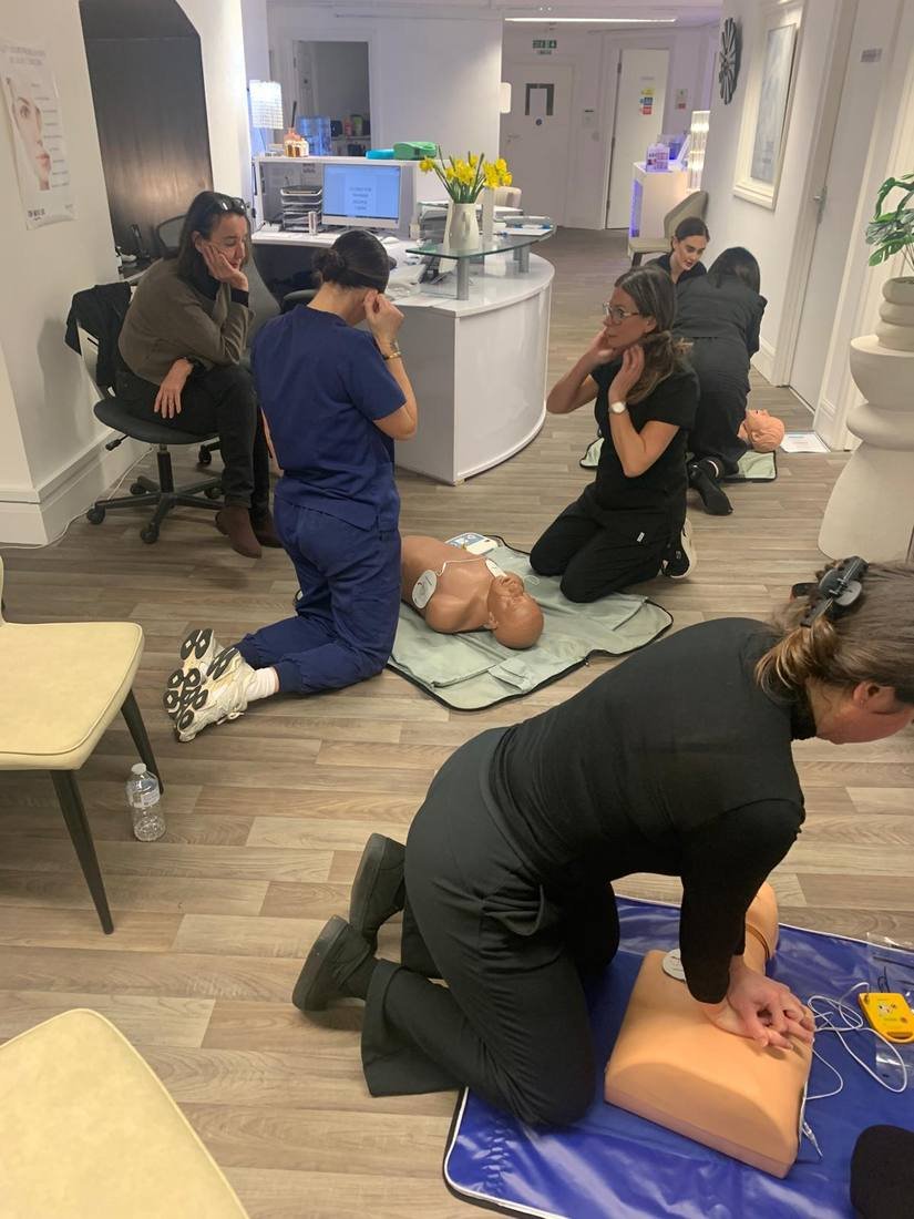 Delegates practising CPR on resuscitation manikins during an on-site first aid course