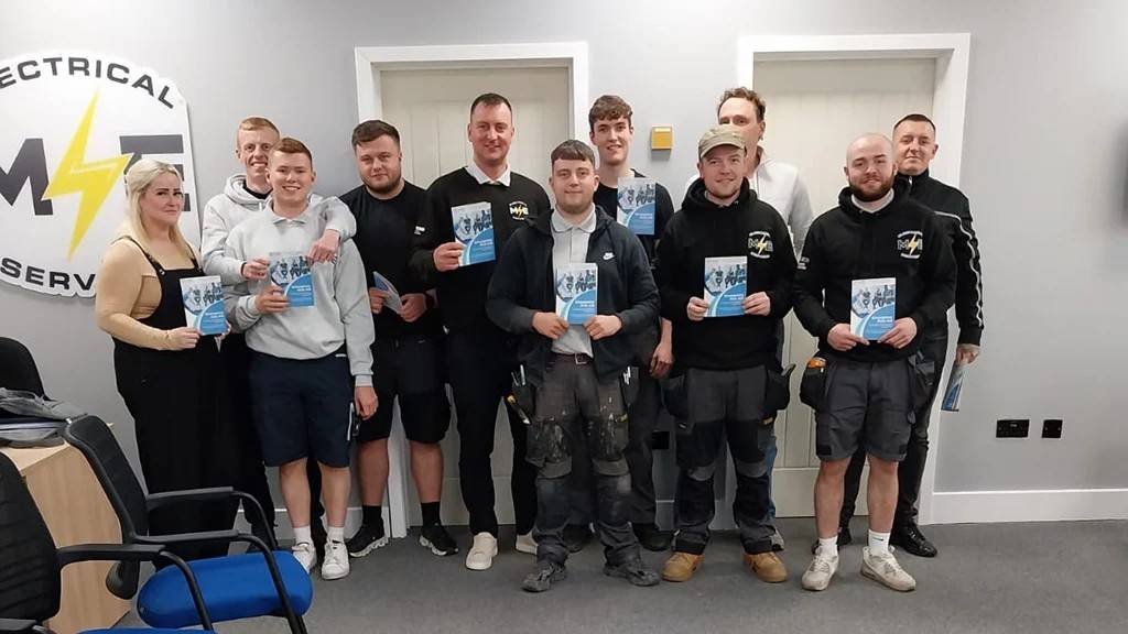 Group of delegates holding their certificates after an on-site first aid course